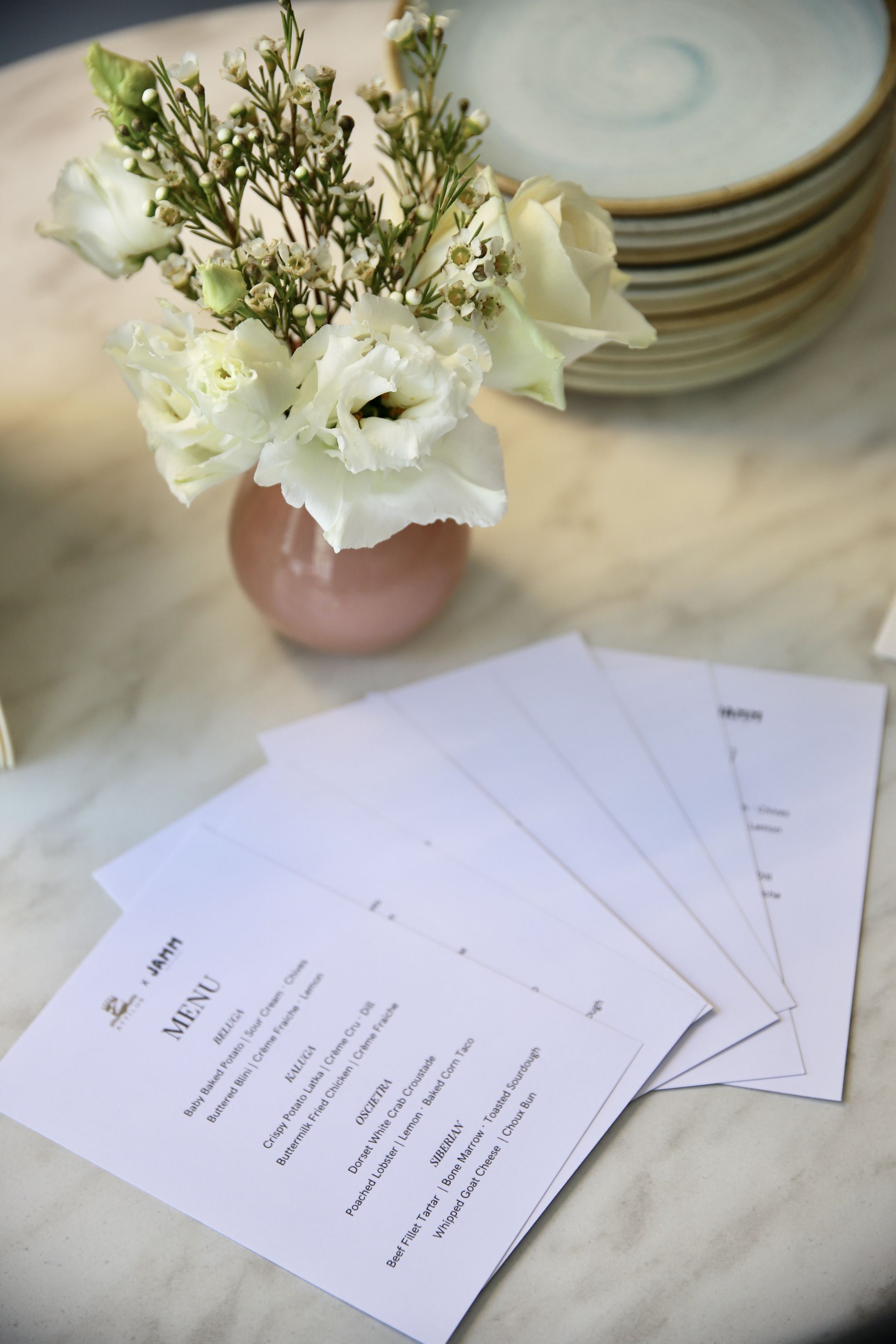 The table set with menus and flowers before the evening.