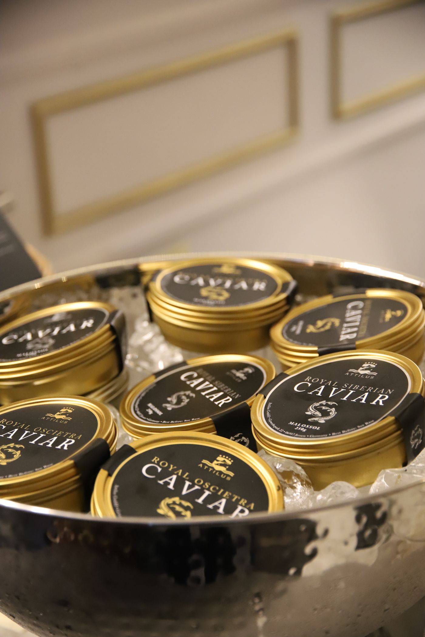 Attilus caviar tins stacked on ice.