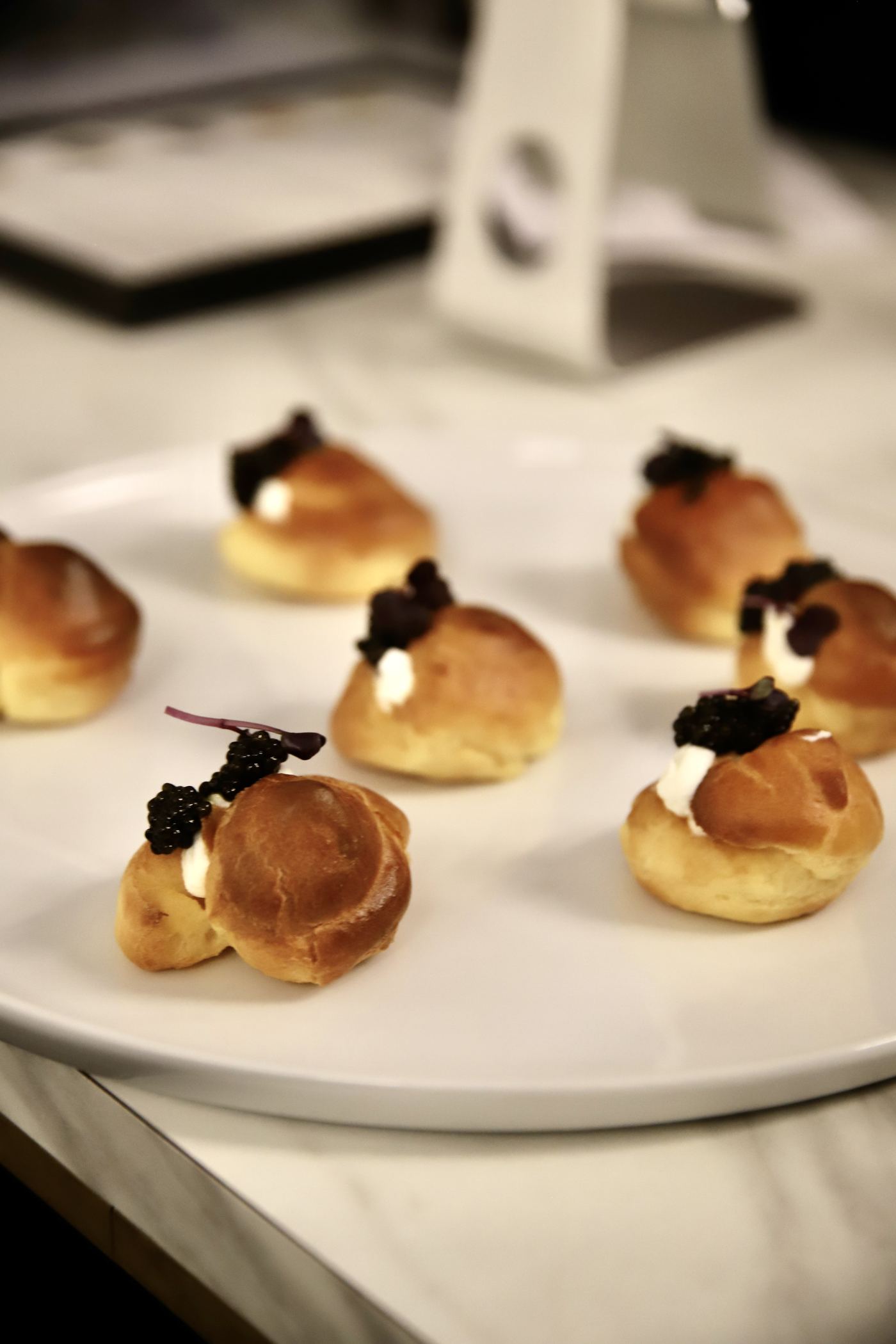 A close detail of a finished canapé on the serving board.
