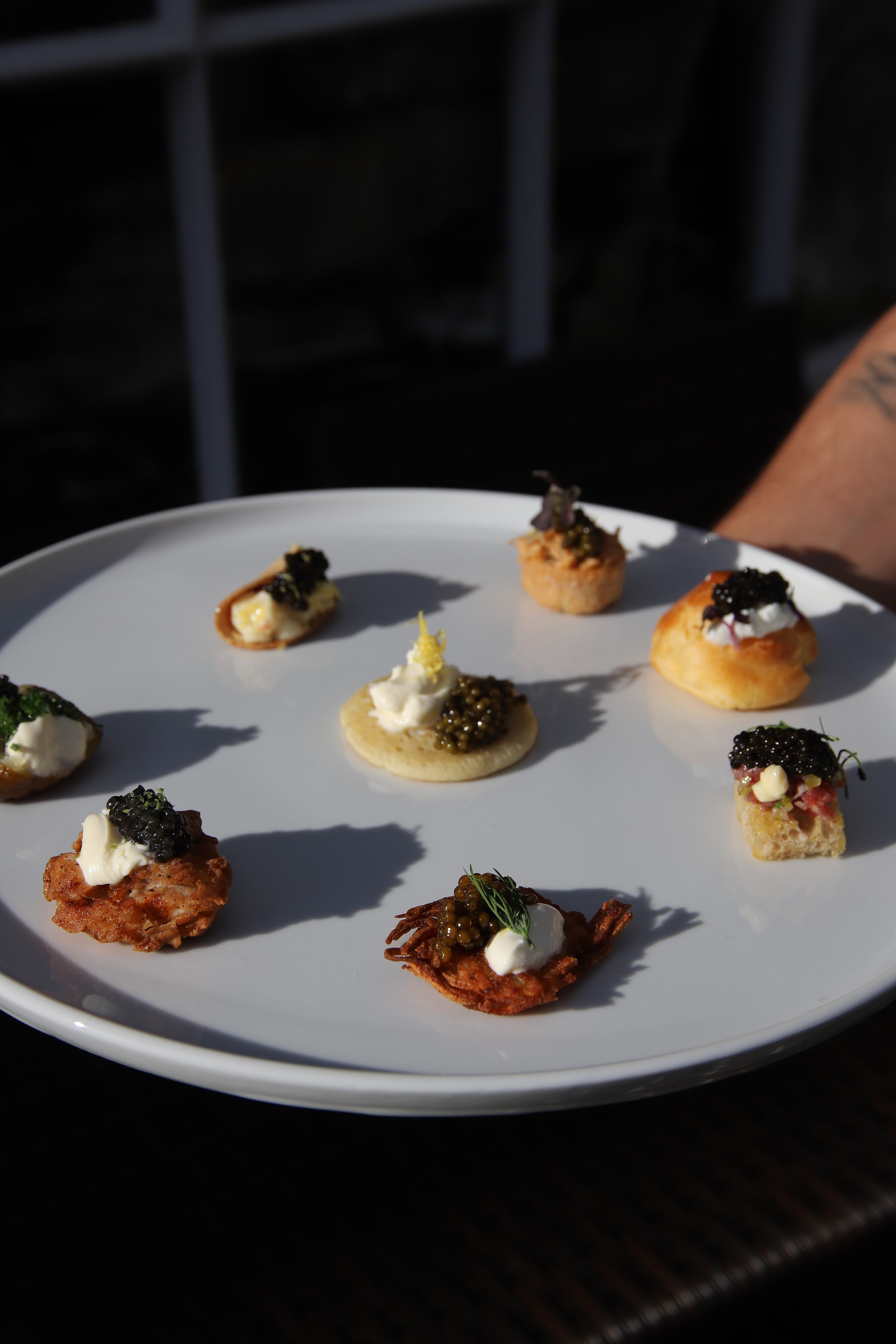 A plate of caviar canapés in the afternoon light at the Attilus and JAMM evening.